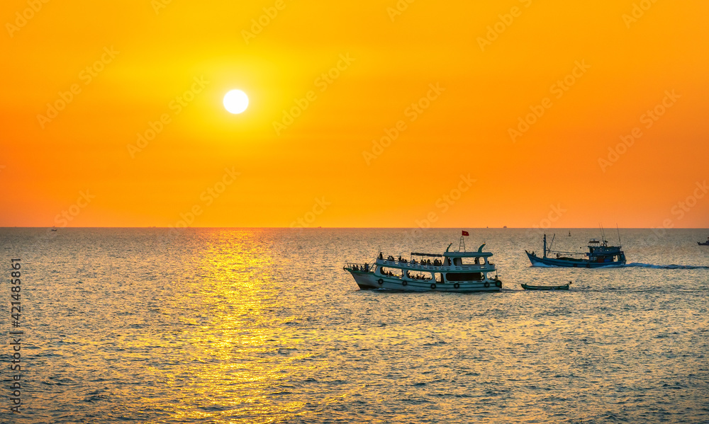 Sunset on the beautiful bay when the fishing boat faces the sun is also the end of the day at the pearl island of Phu Quoc, Vietnam.