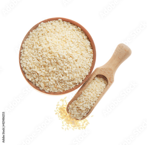 Bowl and scoop with sesame seeds on white background, top view photo