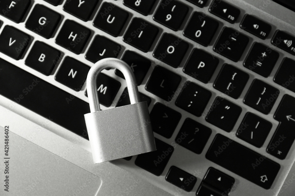 Metal lock on laptop, top view. Cyber security concept Metal lock on laptop, top view. Cyber security concept