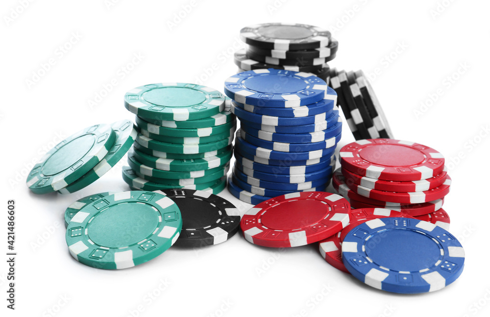 Plastic casino chips stacked on white background. Poker game Plastic casino chips stacked on white background. Poker game