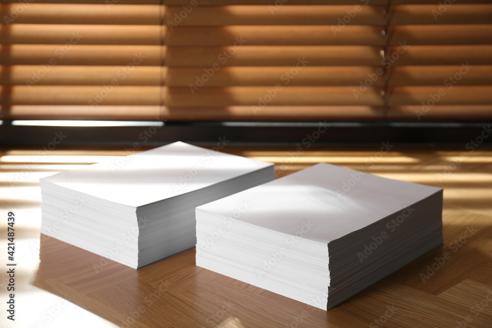 Stacks of paper sheets on wooden table Stacks of paper sheets on wooden table
