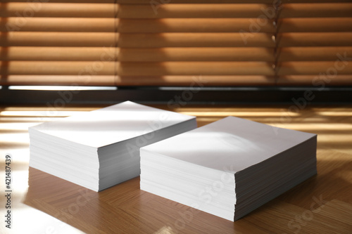 Stacks of paper sheets on wooden table