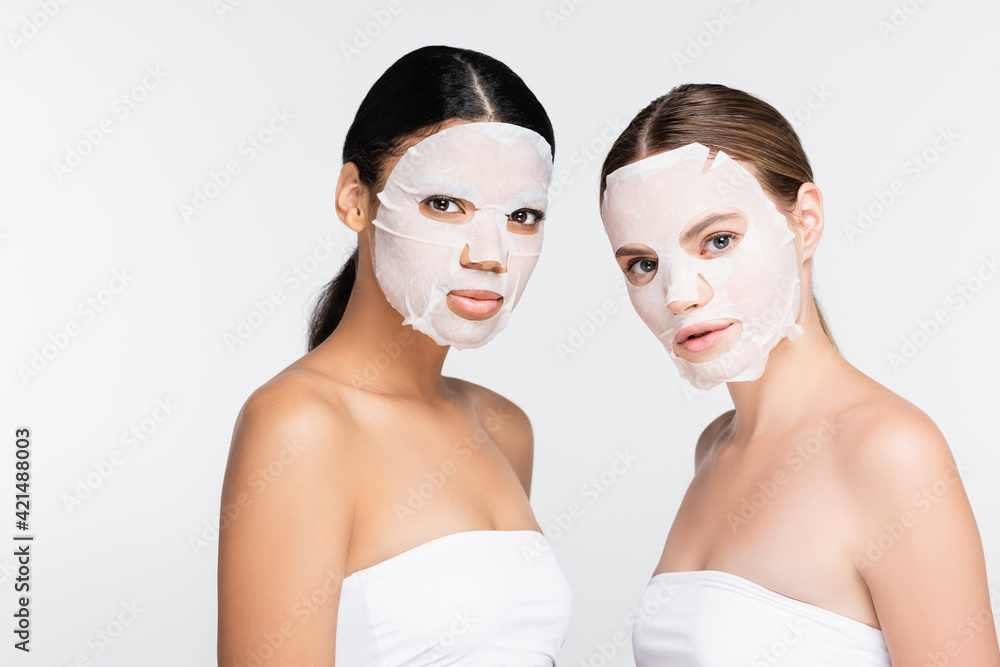 interracial women in sheet masks isolated on white interracial women in sheet masks isolated on white