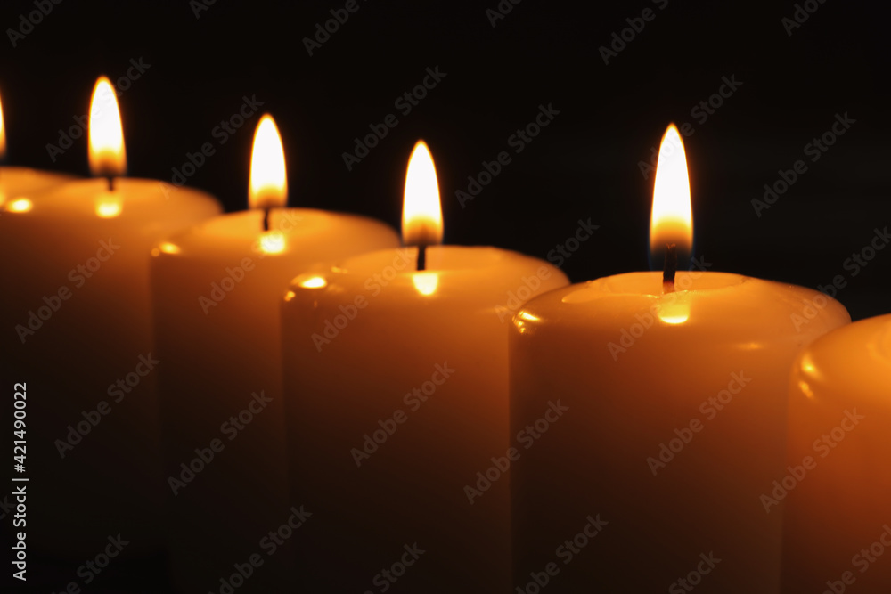 Burning candles on dark background, closeup. Memory day Burning candles on dark background, closeup. Memory day