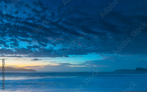 Sunrise seascape at the beach with haze and cloud