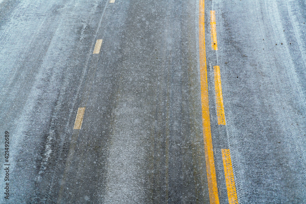 Close up image of road asphalt covered in snow and ice on a cold snowy winters day. Close up image of road asphalt covered in snow and ice on a cold snowy winters day.
