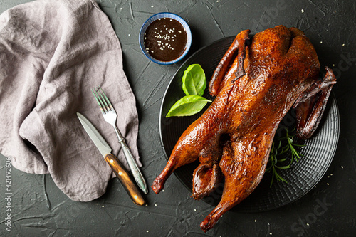 Peking duck with sauce on a dark table