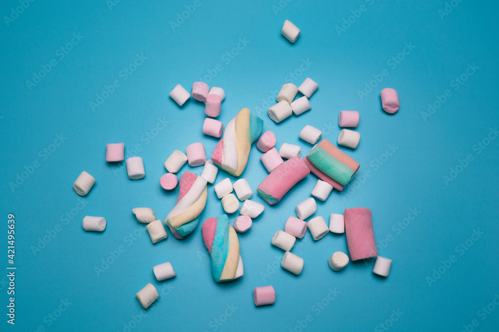 Marshmallows on the blue background, flat lay. Top view, colorful flat lay. Beautiful picture for birthday, holiday cards, for banners or social media. Marshmallows on the blue background, flat lay. Top view, colorful flat lay. Beautiful picture for birthday, holiday cards, for banners or social media.