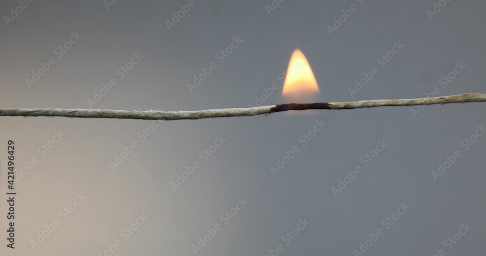 String burns with flame and falls apart Stock Photo | Adobe Stock