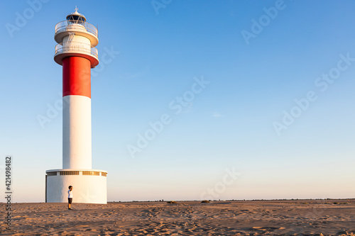 Little kid with a lighthouse background