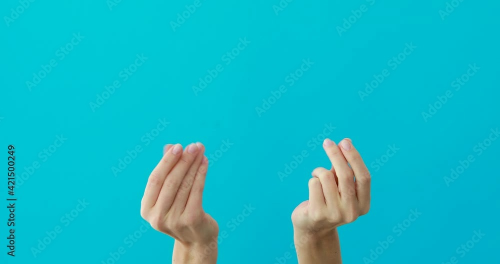 Woman does asking money gestures by hands on turquoise