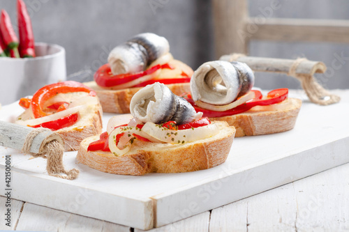 Quadro em tela Summer sandwich with marinated anchovies and seasonal veggies on white wooden tray