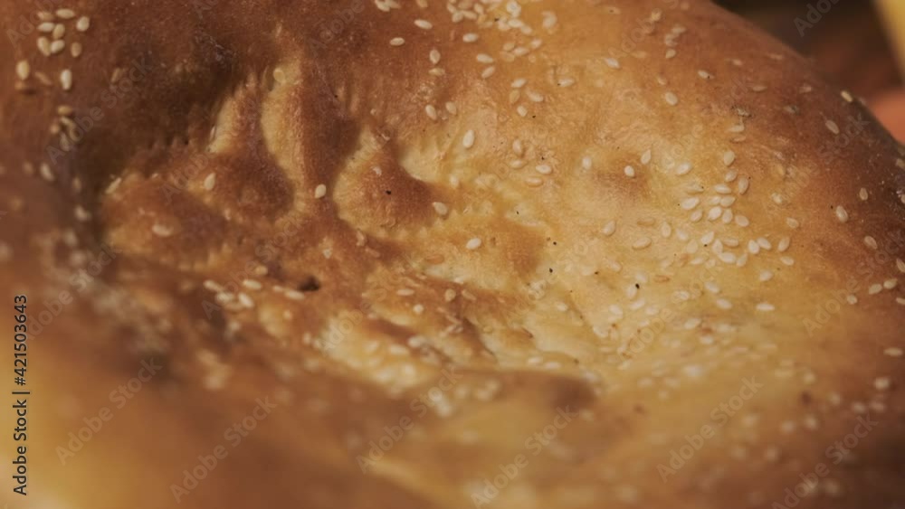 Extreme close up view of Georgian pita bread with sesame seeds. Appetizing bread is macro look. Extreme close up view of Georgian pita bread with sesame seeds. Appetizing bread is macro look.