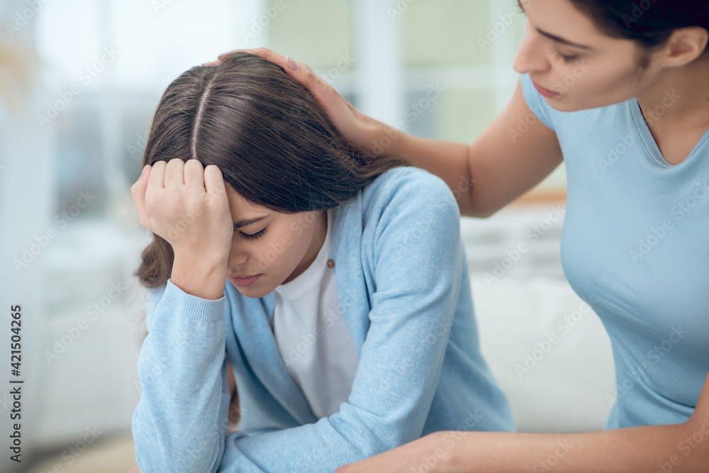 Upset daughter and soothing understanding mom touching Upset daughter and soothing understanding mom touching