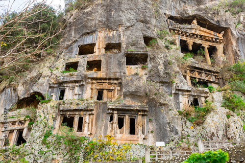 Greek rock hewn tombs on mountain side at ancient Telmessos in Lycia, currently in district of Fethiye in Mugla Province, Turkey photo