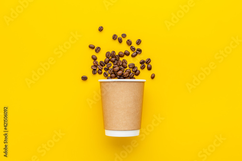 Fototapeta Naklejka Na Ścianę i Meble -  Paper coffee cup with roasted beans. Take away coffee.