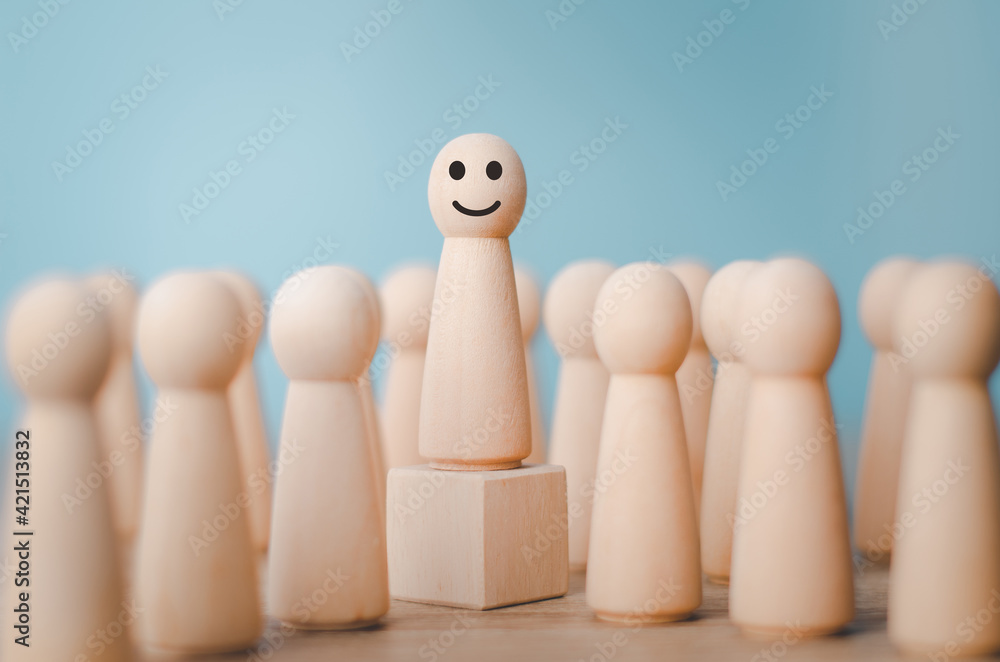 Obraz premium Wood person model among people Smiling .Successful team leader concept.