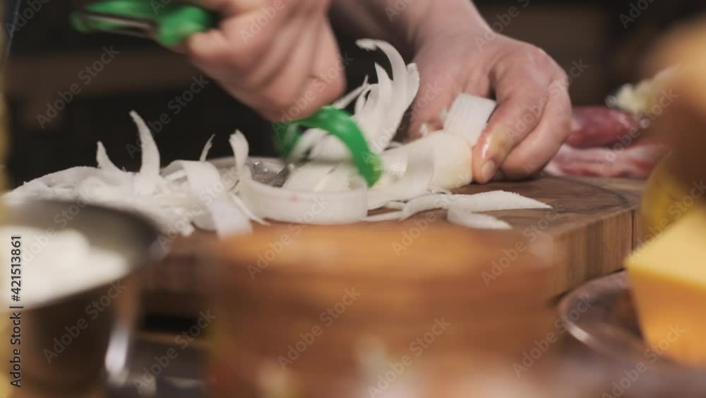 chef cuts daikon radish slices on cutting board. man cooks food in his kitchen. prepare for cooking. vegetarian. chef cuts daikon radish slices on cutting board. man cooks food in his kitchen. prepare for cooking. vegetarian.