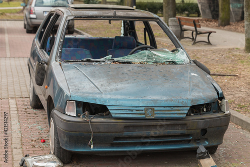 burned and wrecked car in the parking lot