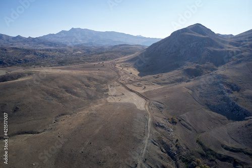 Aerial view of mountain slopes and blue sky.