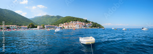panorama coastal landscape Moscenicka Draga tourist resort with boats and bathing beach, ucka mountains photo
