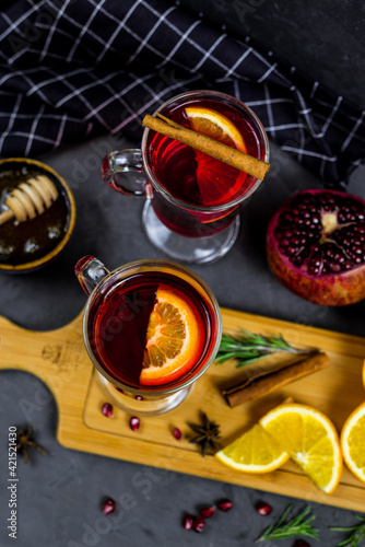 mulled wine in a transparent glass. orange, pomegranate, cinnamon, cardamom, spices. fruit compote. pomegranate tea. warming drink  © Екатерина Столяренко