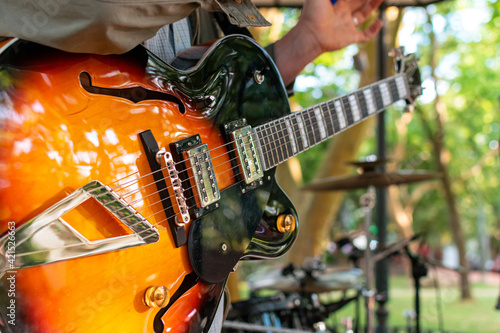 A close-up of a guitar in a stage during a concert 