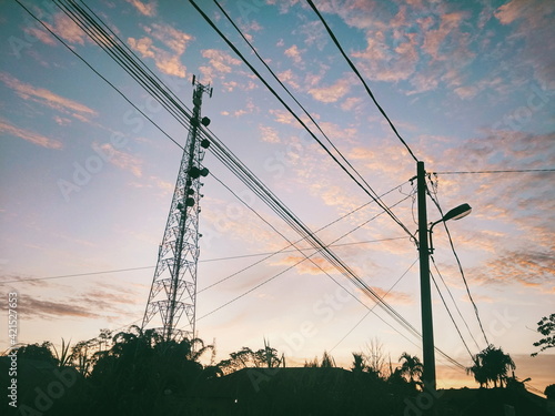 Low Angle View Of Silhouette Electricity Pylon Against Sky During Sunset