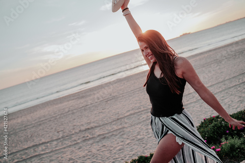 young woman with hat on beach on vacation