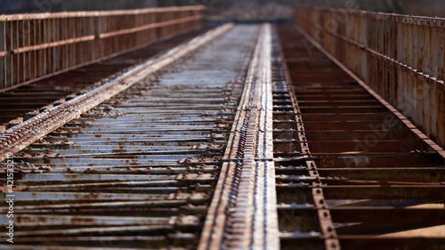 Fototapeta Naklejka Na Ścianę i Meble -  A closed railway bridge in Skwierzyna. Close-ups on the bridge structure. Picture taken in the early afternoon, sunny weather