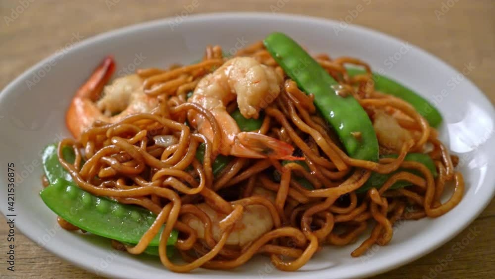 stir-fried yakisoba noodles with green peas and shrimps - Asian food style stir-fried yakisoba noodles with green peas and shrimps - Asian food style