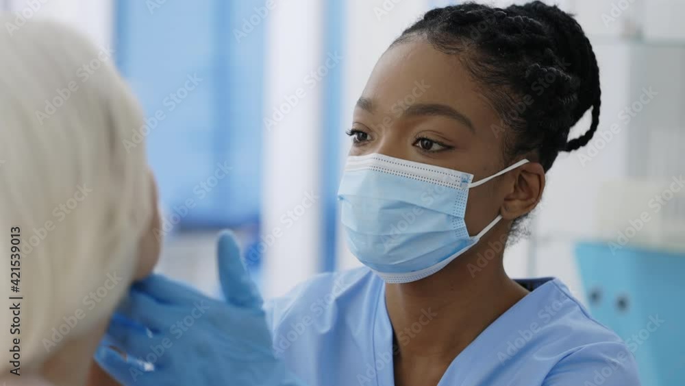 Crop view of medical female worker in protective mask and gloves taking PCR test sample from elederly patient in hospital room. Concept of Covid reaesearch and diagnostic. Crop view of medical female worker in protective mask and gloves taking PCR test sample from elederly patient in hospital room. Concept of Covid reaesearch and diagnostic.