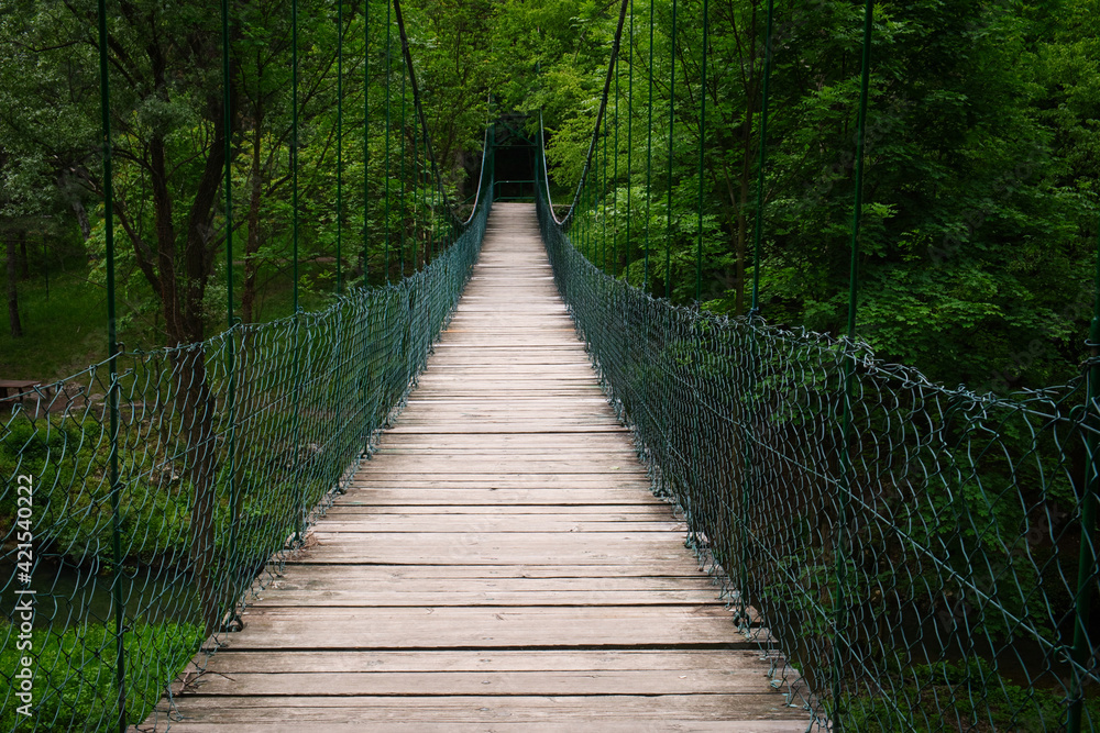 Obraz premium Old wooden hanging bridge upon the mountain leading from the Lazar cave in Lazarev canyon, Serbia