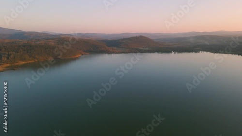 Wallpaper Mural Aerial footage over a lake at sunset in autumn with lake banks mirroring in the water. Drone video of a lake with birds and trees at sunset. Torontodigital.ca