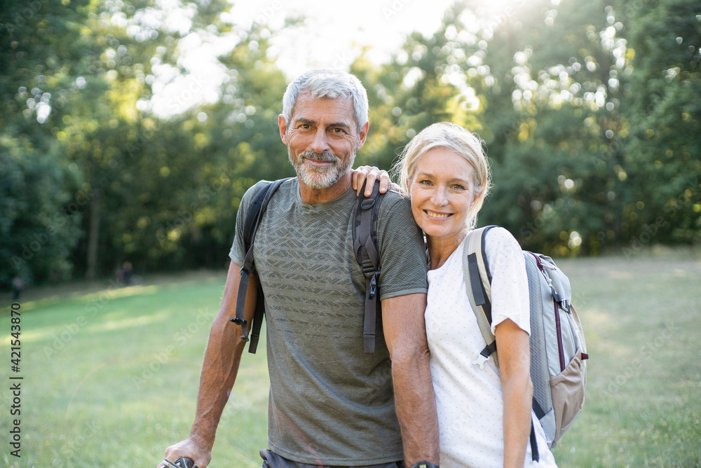 Portrait of smiling mature couple standing in forest Portrait of smiling mature couple standing in forest