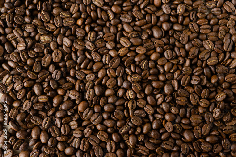 Roasted coffee beans background, brown color, top view