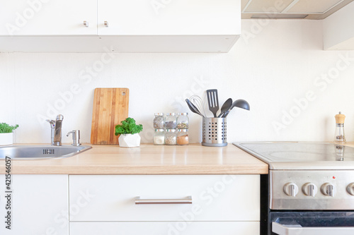 Scandinavian classic minimalistic kitchen with white and wooden details. Modern white kitchen clean contemporary style interior design.