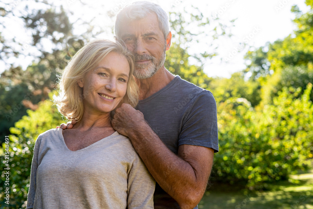 Portrait of smiling mature couple standing in backyard Portrait of smiling mature couple standing in backyard