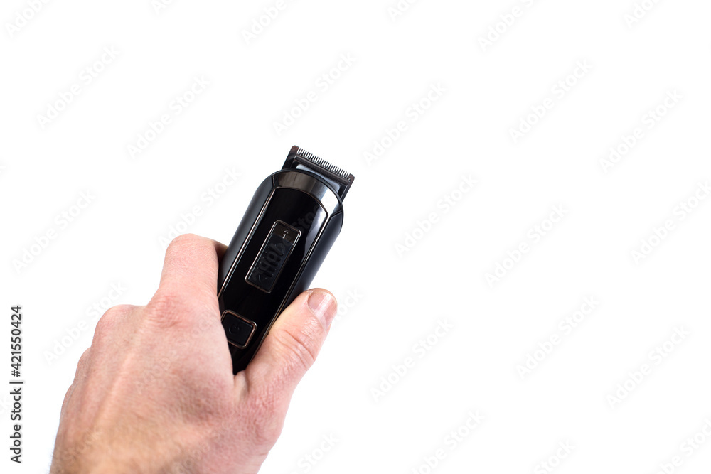 Male hand holding razer. Shaving machine in hand isolated on a white. Male hand holding razer. Shaving machine in hand isolated on a white.