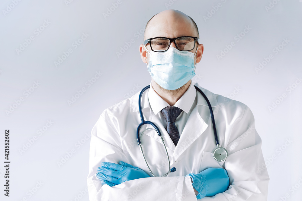 doctor wearing a protective mask and gloves looks at you confidently. doctor wearing a protective mask and gloves looks at you confidently.