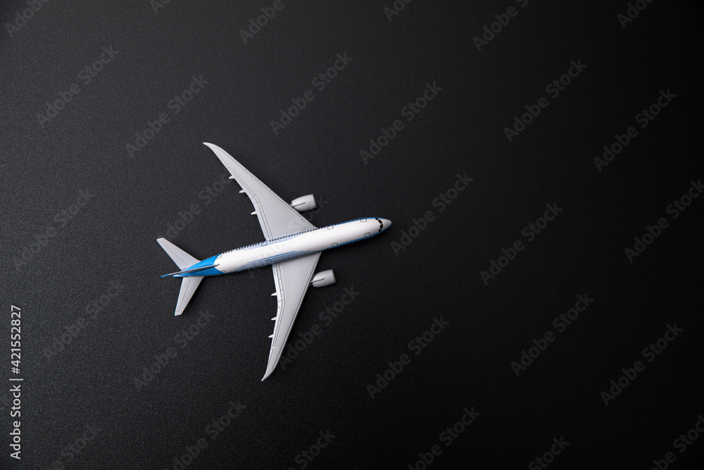 White model airplane on black background