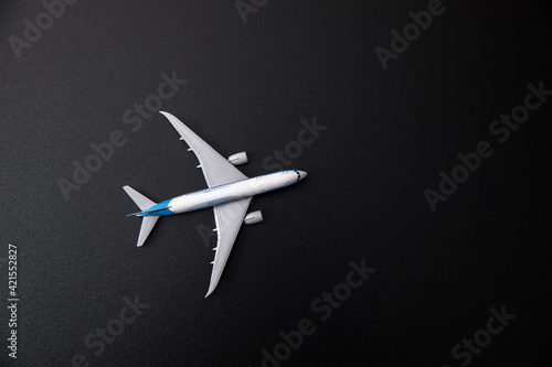 White model airplane on black background