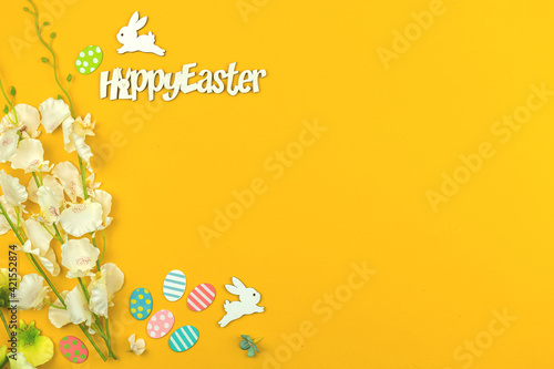 Festive and holiday workspace concept, happy easter text on a yellow background, copy space
