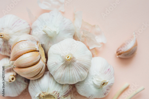 Garlic bulbs on pink background  close-up. Organic garlic top view. Food background. Selective focus.