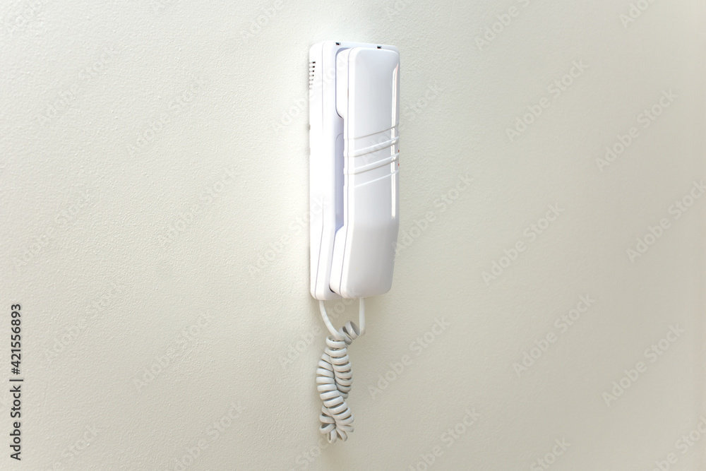 Intercom on white wall at home. Phone comunication in house concept with copy space. Intercom on white wall at home. Phone comunication in house concept with copy space.