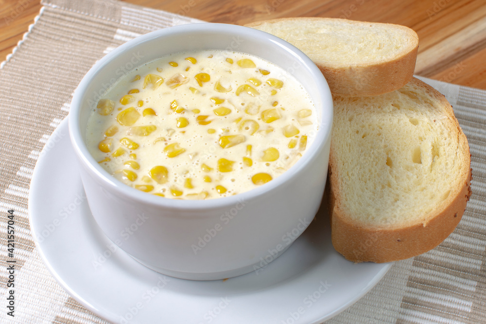 Corn flakes with gratin cheese, accompanied by bread on wooden background Corn flakes with gratin cheese, accompanied by bread on wooden background