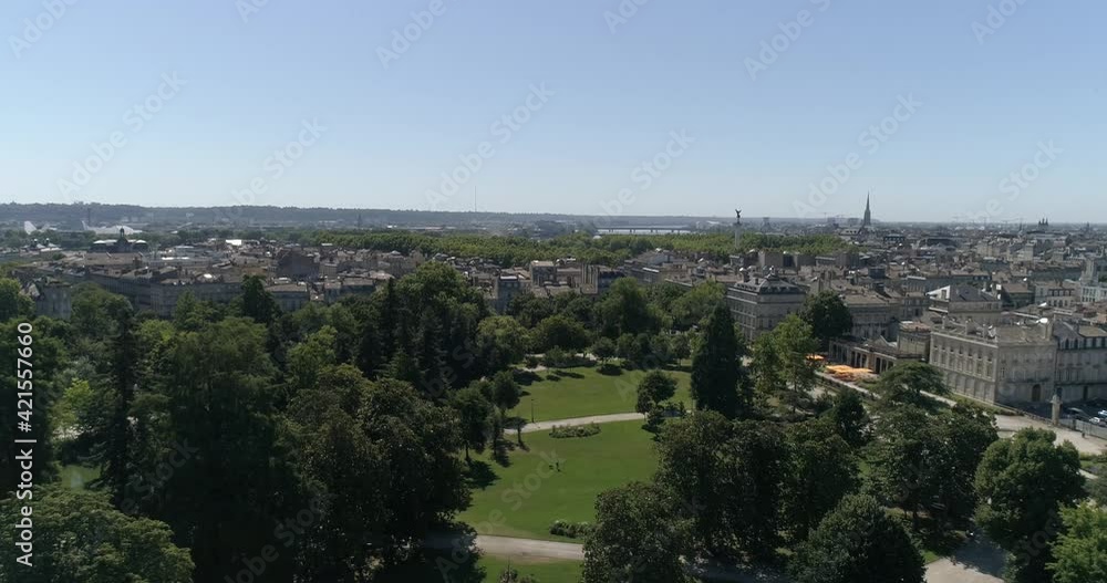 Jardin Public in Bordeaux France with trees on grass and Monument of Girondins in the distance, Aerial dolly right reveal shot Jardin Public in Bordeaux France with trees on grass and Monument of Girondins in the distance, Aerial dolly right reveal shot