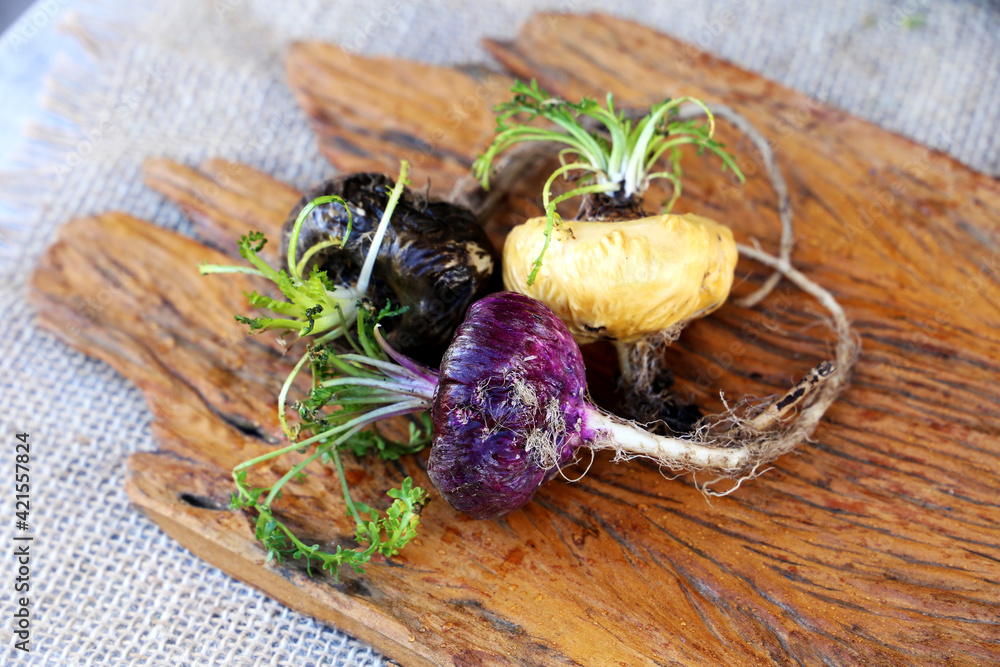 Fresh maca roots or Peruvian ginseng (lat. Lepidium meyenii) with maca products (maca powder) Fresh maca roots or Peruvian ginseng (lat. Lepidium meyenii) with maca products (maca powder)