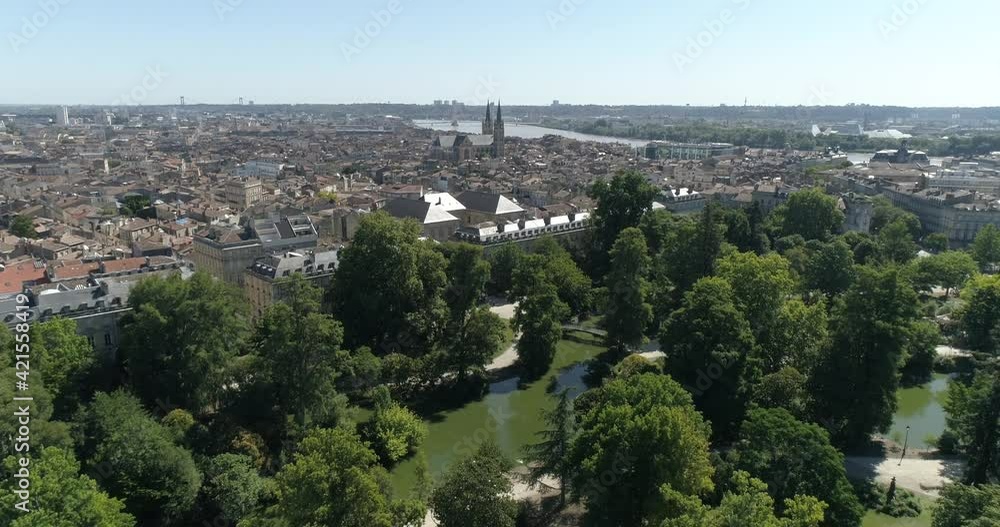 Lake of Jardin Public in Bordeaux France, with Saint-Louis des Chartrons church near the Garonne river in France, Aerial dolly out descent shot Lake of Jardin Public in Bordeaux France, with Saint-Louis des Chartrons church near the Garonne river in France, Aerial dolly out descent shot
