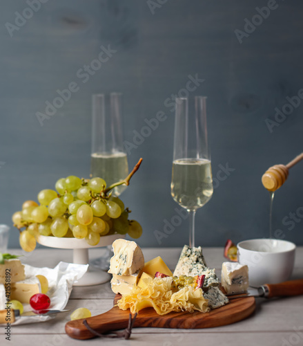 White wine is traditionally combined with various types of cheese.Cheese plate (board).White grapes, honey.
